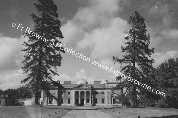 FRONTAL VIEW OF HOUSE WITH CLOUDS FROM AVENUE